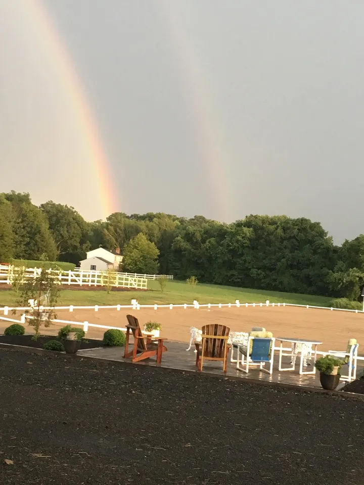 A double rainbow over the outdoor arena and patio at Lepore Farm